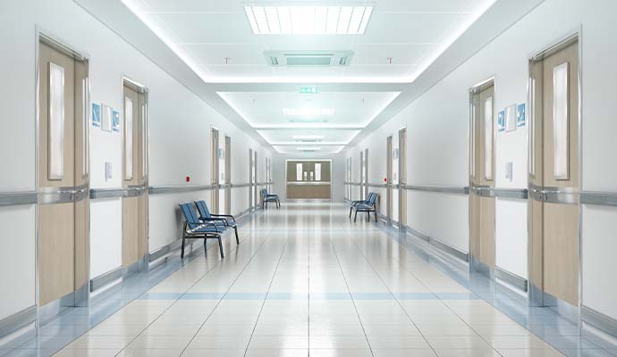 A clean hospital corridor featuring polished tile floor
