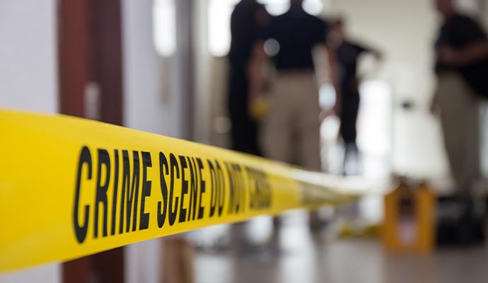 Crime scene area sealed with yellow caution tape for investigation
