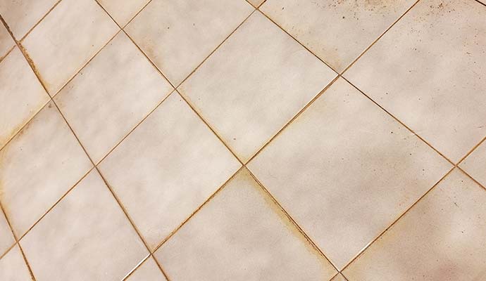 Dirty and discolored white tile grout