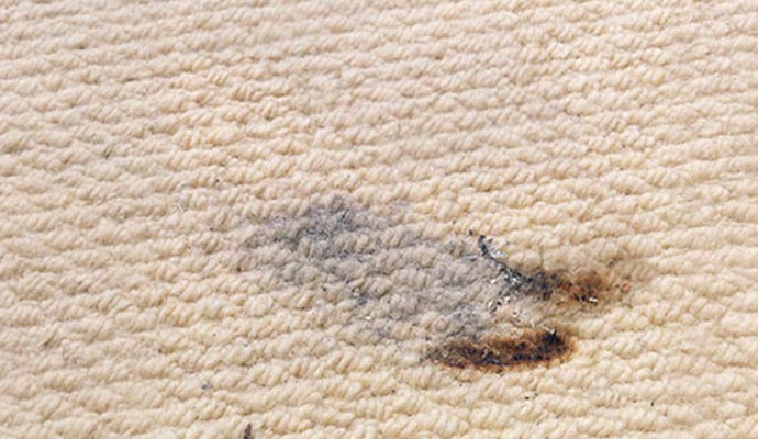 Burn mark on carpet due to candle fire