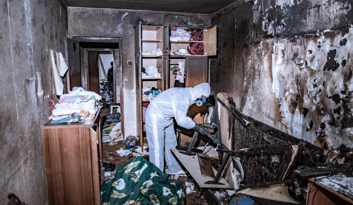 Professional worker restoring a fire damaged room Professional worker restoring a fire damaged room