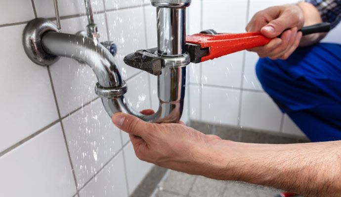 A person is fixing plumbing leak