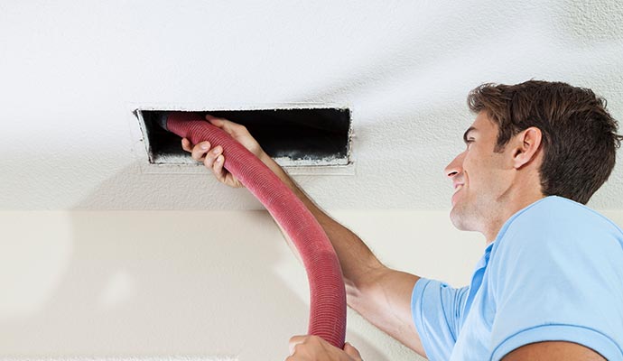 Professional worker cleaning duct with an equipment
