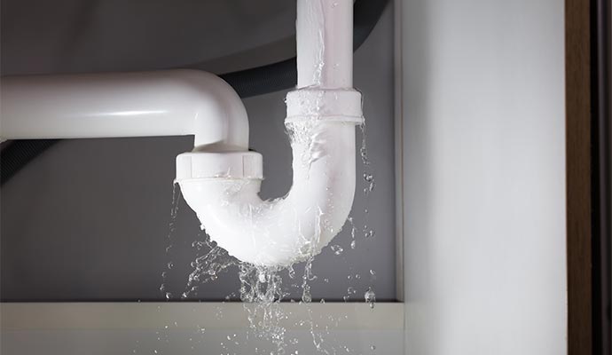 Water leaking from broken pipe under sink